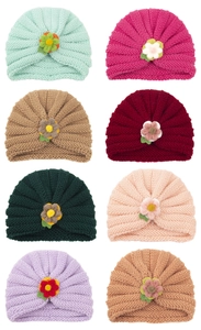 Detail of baby turban hats showing ribbed knit texture and handmade crochet floral patterns