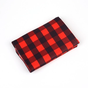 Detail of red and black buffalo plaid fabric showing neat stitching and high-quality texture