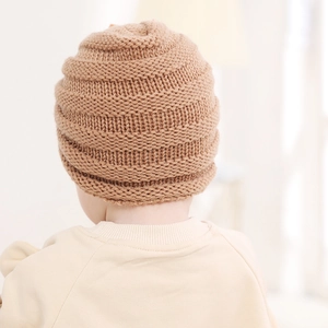 Close-up of khaki knitted baby hat showing thick wave texture and warm ribbed design