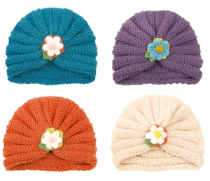 Detail of baby knit turban hats featuring handmade crochet flowers and ribbed edges