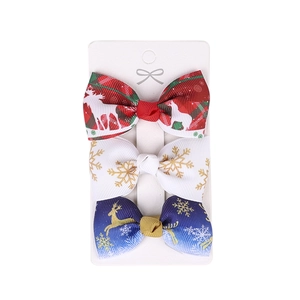 Three-piece Christmas bow hair clip set with reindeer and snowflake patterns on white card