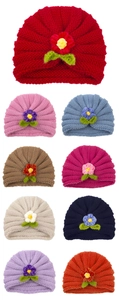 Multiple colors of baby knitted beanies with handcrafted flower and leaf details