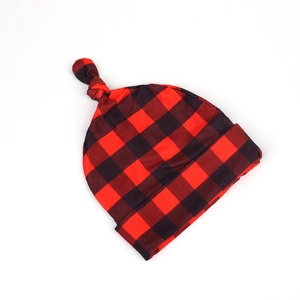 Detail of red and black buffalo plaid infant knot hat in soft stretch knit fabric