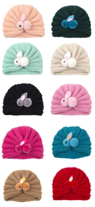 Close-up of baby knit turban hats in ten vibrant colors featuring cute plush bunnies