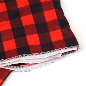 Macro detail showing overlock stitching on buffalo plaid newborn swaddle fabric