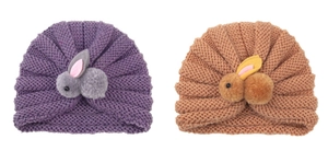 Detail view of two knitted baby hats in purple and tan with cute 3D plush bunnies