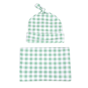 Green and white plaid baby swaddle blanket and matching top knot hat set for newborns