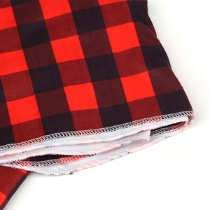 Detail shot of red and black buffalo plaid swaddle blanket with white edge stitching
