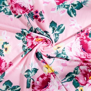 Detail of pink floral maternity fabric with peonies and roses for newborn swaddles