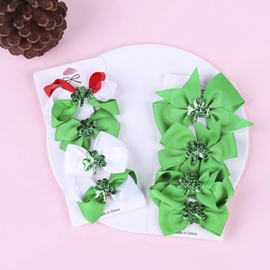 Detail of St. Patrick's Day hair clips with green clover bows on white display card