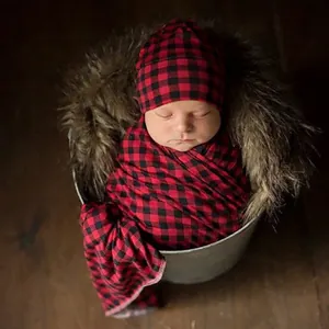 Newborn swaddle set with red and black plaid wrap and matching knit hat for photo props
