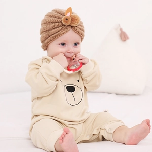 Infant knitted hat with plush rabbit detail and matching long-sleeved bear romper
