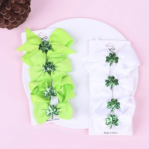 Detail of St. Patrick's Day clover hair bows in green and white on display cards