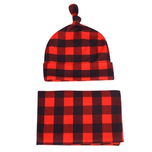 Newborn swaddle set with red and black buffalo plaid blanket and top knot hat