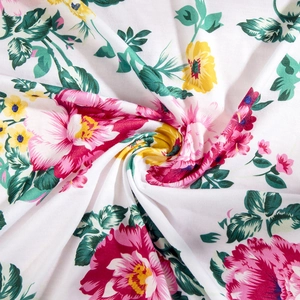 Detailed close-up of soft floral fabric with vibrant pink flowers and green leaves