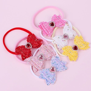 Detail of sequin bow headbands with heart rhinestones and elastic nylon hair bands