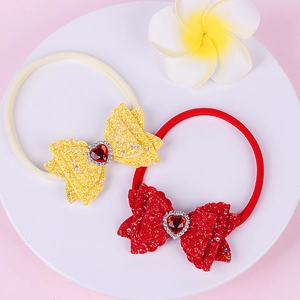 Detail of baby nylon headbands with sequin bows and heart-shaped rhinestone center in two colors