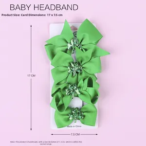 Detail of four green St. Patrick's Day hair bows with sequin shamrocks on a display card