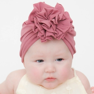 Dettaglio del turbante per neonato rosa antico con grande fiore 3D in tessuto morbido