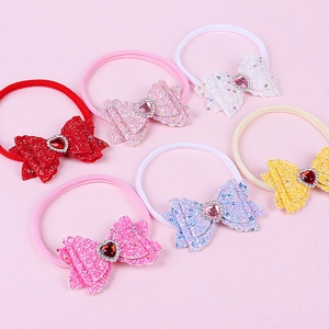 Detail of baby nylon headbands with glittery bows and heart rhinestones in six colors