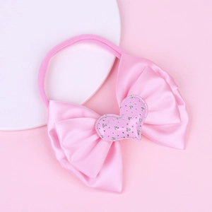 Pink infant nylon headband with large satin bow and silver glitter heart ornament
