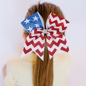 Detailed view of large Fourth of July girls hair bow with stars stripes and silver rhinestones