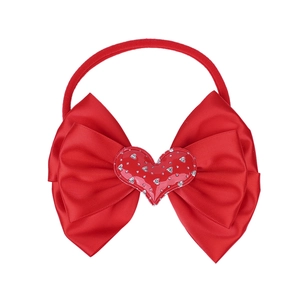 Red nylon baby headband with layered satin bow and decorative heart centerpiece