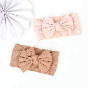 Close-up of pink and tan ribbed cotton baby headbands with large handmade bows