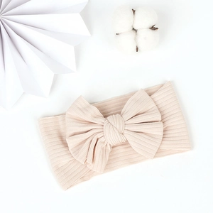 Close-up of soft ribbed cotton baby headband with a large decorative bow tie