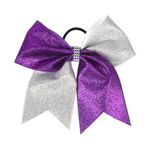 Detail of purple and silver glitter hair bow with rhinestone center and elastic band