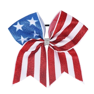 Detail of glitter American flag bow hair tie with stars and stripes for girls