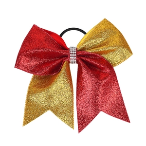 Detail of red and gold glitter bow hair tie with rhinestone ring and black elastic band