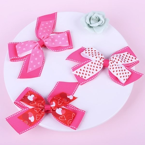 Handmade layered heart print hair bows for girls on a decorative tray for Valentine's Day