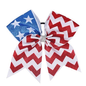 Close-up of glitter ribbon hair bow with stars stripes and rhinestone center detail