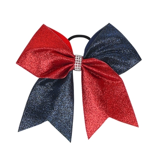 Detail of red and blue glitter cheer bow with rhinestone center and elastic band