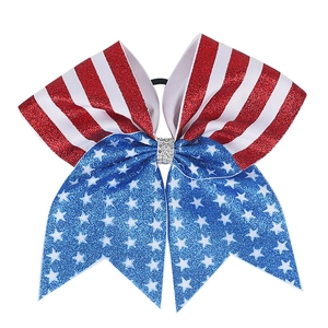 Detailed view of patriotic US flag sequin bow hair tie with sparkling rhinestone center