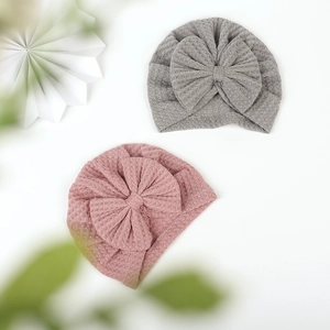 Infant waffle knit turban hat with large bow decoration in grey and pink purple color