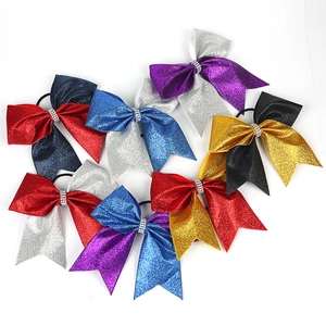 Detail of sparkly sequin bow hair ties with rhinestone center in assorted vibrant colors