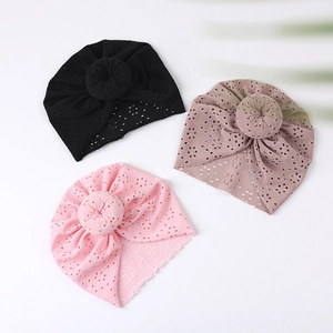 Detail view of breathable eyelet fabric and donut knot design on baby turban caps
