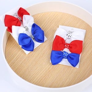 Close-up of red, white, and blue grosgrain ribbon bows with rhinestones for Independence Day