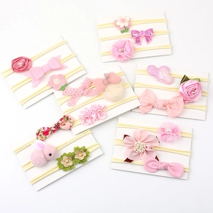 Detailed set of pink baby headbands featuring chiffon flowers, sequins, and plush bunnies