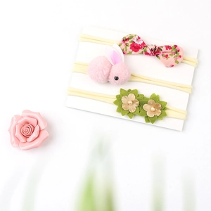 Three-piece infant headband set with floral bow, pink rabbit, and felt flower detail
