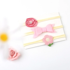 Detail of baby nylon headbands with satin rose, felt bow, and crochet flower accents