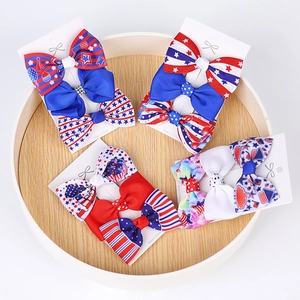 Close-up of July 4th grosgrain ribbon bow clips with star and stripe patterns