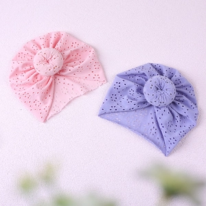 Detail of pink and purple baby turban hats with donut knots and breathable eyelet fabric