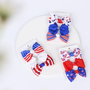 Close-up of three US Independence Day themed hair bows with star and stripe patterns