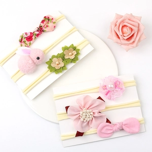 Detail showing set of six baby nylon headbands with pink bows and floral patterns