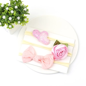 Detailed set of three pink baby nylon headbands with sequins heart and rose flower decor