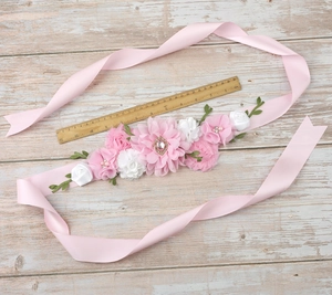 Detail of pink and white fabric flowers on maternity belt with a ruler for scale