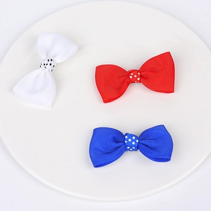 Detail of three grosgrain ribbon hair bows in red white and blue with white polka dots
